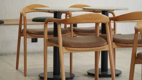 Empty chairs at a cafe in the afternoon sun Stock Footage 333605167