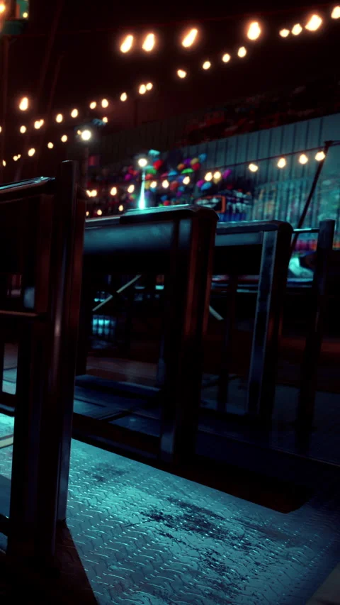 Empty chairs in a dimly lit space with colorful lights above Vídeo Stock 339773143
