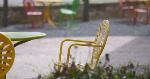 Empty Chairs on Patio by Road 4K 23.98 Truck Left Tilt Up Video stock 132821779
