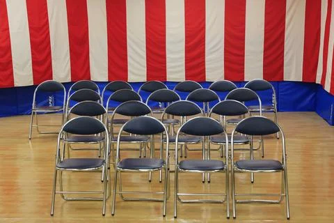 Empty chairs striped backdrop event preparation Stock Photos