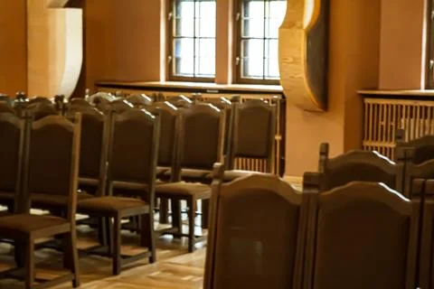 Empty chairs in a warm lit hall Stock Photos
