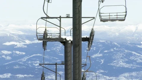 Empty chairs without tourists circulating on chairlift high in mountains Stock Footage 129116308