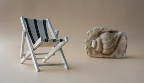 An empty chaise longue and a seashell . Summer concept, tourism, pandemic, co Stock Photos