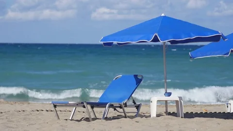 Empty Chaise Longue Under Sun Umbrella on the Ocean Coast Stock Footage 81170116