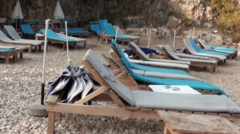 Empty chaise longues at the beach Stock Footage 30462858