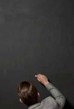 Empty chalk black board with chalk in the hand Stock Photos