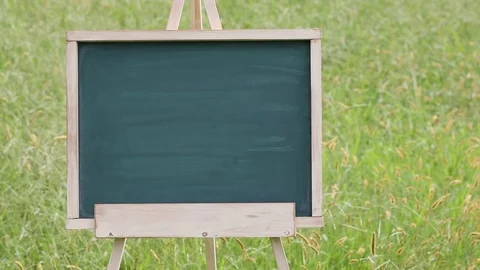 Empty chalkboard with easel on green field Stock Footage 77631806
