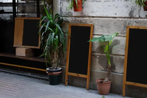 Empty chalkboards with wooden frames lining a sidewalk cafe Stock Photos