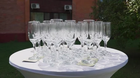 Empty champagne glasses on a table outdoors Stock Footage 329248206