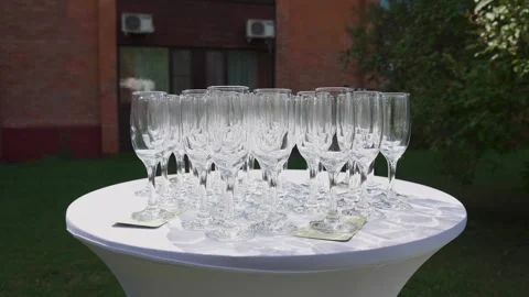 Empty champagne glasses on a table outdoors Stock Footage 329248213