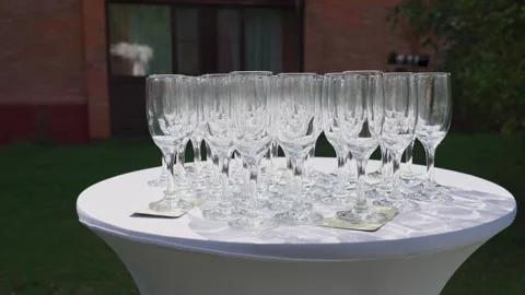 Empty champagne glasses on a table outdoors Stock Footage 329248235
