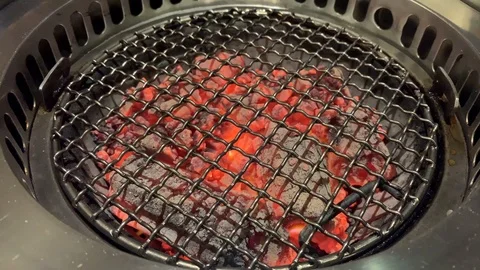 Empty charcoal grill, placed in a smoke remover in a restaurant Stock Footage 102928187