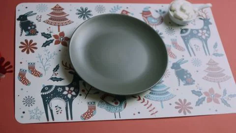 Empty charcoal plate centered on holiday artwork Stock Photos