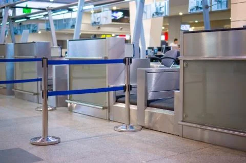 Empty check-in desks with computers and waiting lines in front in airport Stock Photos