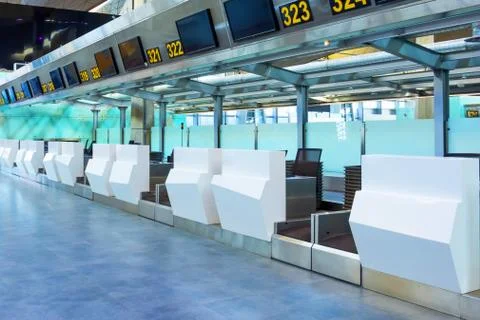 Empty check-in desks for drop off baggage with paths canceled at the airport  Stock Photos