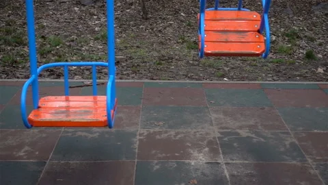 Empty child swing seats swing in slow motion Stock Footage 130707353