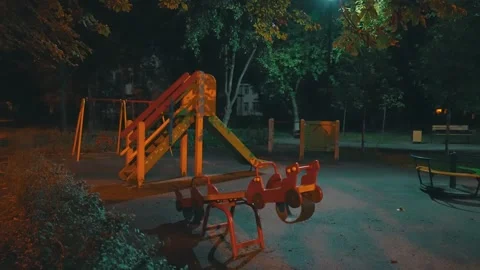 Empty Children Playground at Night with Slide Swing and Merry-Go-Round Stock Footage 317130189