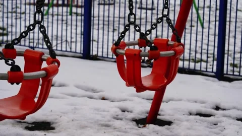 Empty children swing on cold winter day after snowfall Video stock 310201764
