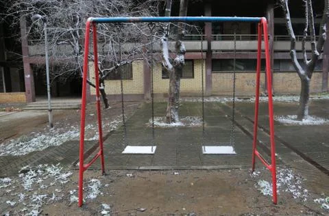 Empty children swing on playground Stock Photos