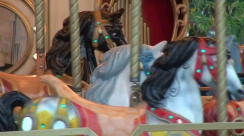 Empty children's carousel horse spinning around, merry-go-round, amusement park Stock Footage 30934507