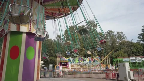 An empty children's carousel rotates in the park. Stock Footage 159824587