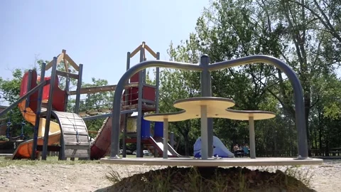 Empty Children's Carousel Spinning in the Playground Stock Footage 244310978