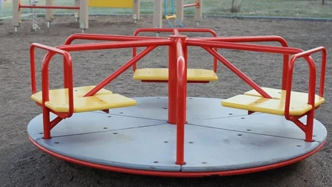 Empty Childrens Carousel Spins on the Playground. The concept of Childhood Stock Footage 157064241