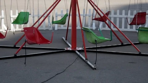 Empty children's carousel swinging on chains Stock Footage 117294869