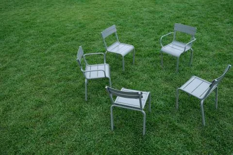 Empty children's chairs on the green grass in the Park Stock Photos