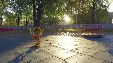 Empty children's playground. Autumn city landscape. Slow motion steadicam Stock Footage