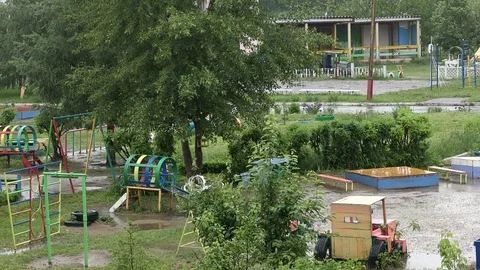An empty children's Playground in the rain Stock Footage 77266000