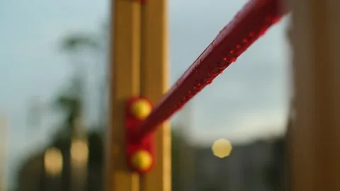 Empty children's playground in the rain. Rain drops falling on swing, wet Stock Footage 251733767