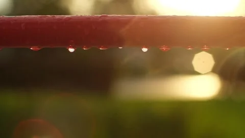 Empty children's playground in the rain. Rain drops falling on swing, playground Stock Footage 251736171