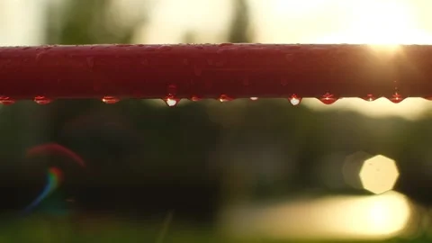 Empty children's playground in the rain. Rain drops falling on swing, no people Stock Footage 251737493