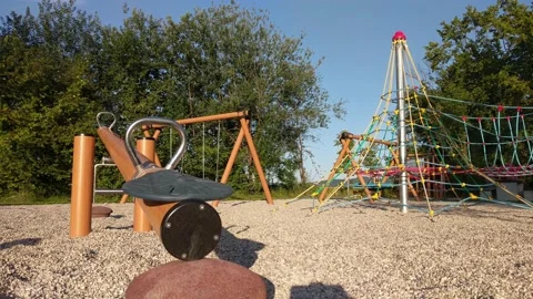Empty children's playground with swing and climbing tower Video stock 134659675