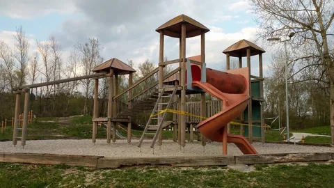 Empty children's playground with warning tape during COVID-19 epidemics Stock Footage 128210835