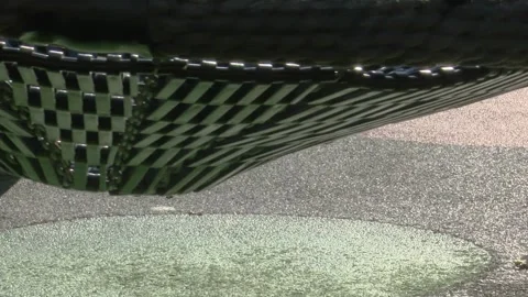 Empty Children’s Swing Moving Gently in Playground Playground Видео 330245125