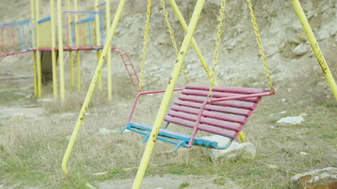 Empty children's swing in Ukraine. The concept of destruction and post Video stock 172211709