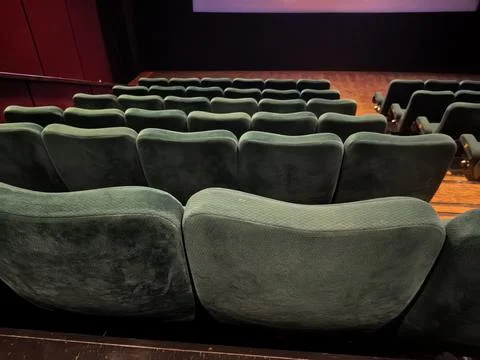 Empty Cinema Auditorium with Rows of Green Theater Seats Stock Photos