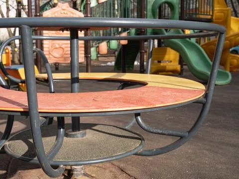 Empty circular rotating playground carousel Stock Photos