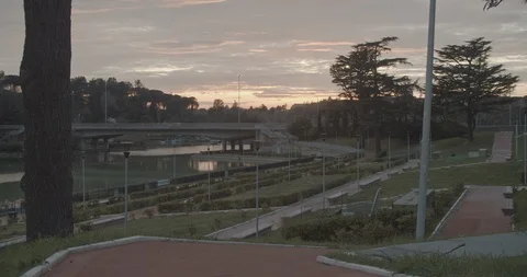 Empty city park, a bridge over a pond at sunset, Stock Footage 127837601