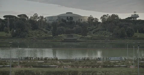 Empty city park with a view over a pond and a building Stock Footage 127795432