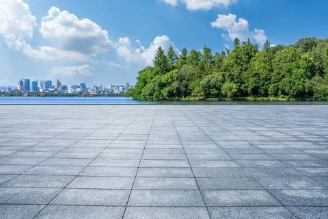 Empty city square and green tree with modern city skyline in Hangzhou. Stock Photos