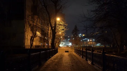 Empty city streets with street lights at night in autumn, dark bridge over river Stock Footage