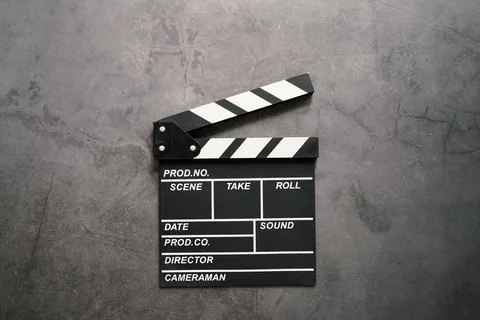 Empty clapperboard in flat lay style on dark stone background, entertainmen.. Stock Photos