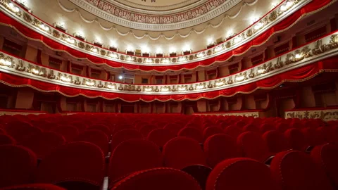 Empty classic theater. Rows of empty red velvet seats inside a theater or opera. Video stock 150663691