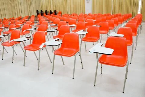 Empty classroom and orange chairs Stock Photos