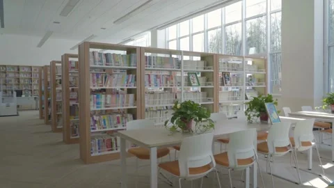 Empty classroom with book shelf, table and chairs to sit for a lesson in mode Stock Footage 256720838