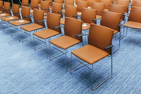 Empty classroom with brown chairs and blue carpet Stock Photos
