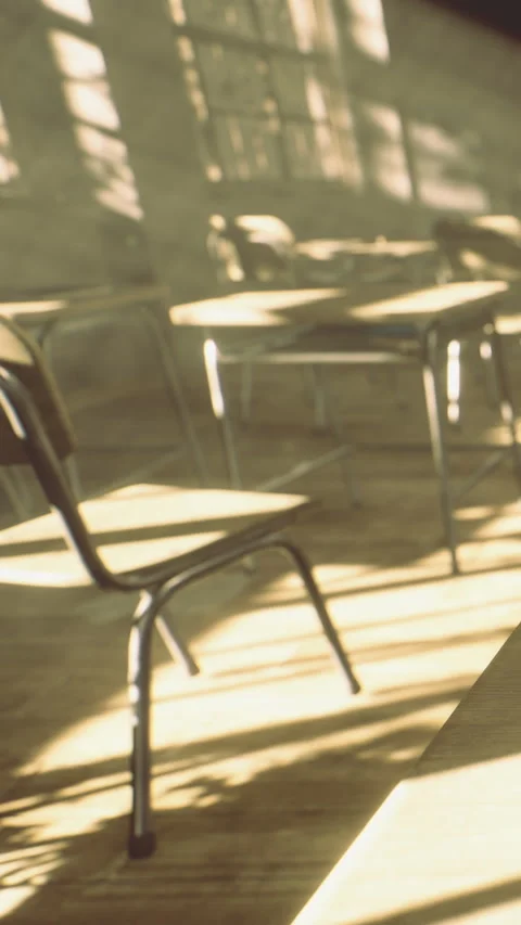 Empty classroom with chairs and desks in sunlight at a school in the afternoon Stock Footage 334260050